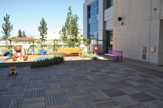 This modular roof deck is supported on pedestals and provides a place for children to both play and heal at the Children’s Hospital of Orange County in California.