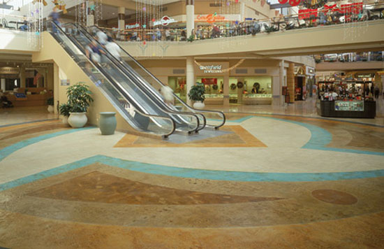 Concrete overlay systems are often driven by a failed concrete slab. In this case, at Superstition Mall in Mesa, Arizona, the owners chose a concrete overlay system for an aesthetically dramatic upgrade.