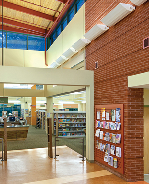 Oakton Library in Oakton, Virginia, is a LEED Silver facility designed by PSA Dewberry, utilizing natural light from clerestories at the entry, which is supplemented with indirect uplighting for evening or cloudy days.