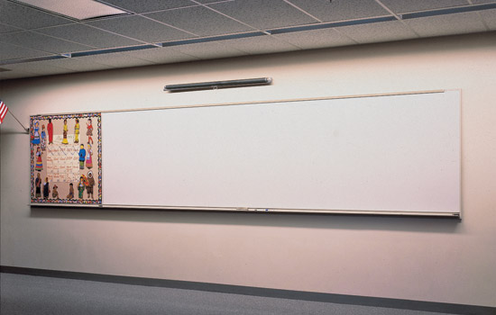 Continuous wall-wash fixtures specified by Greer S.J.C.F. for Derby High School in Derby, Kansas, illuminate the school’s whiteboards and ensure consistent luminance levels within a 3-to-1 ratio between visual tasks at the desk and the front of the room.