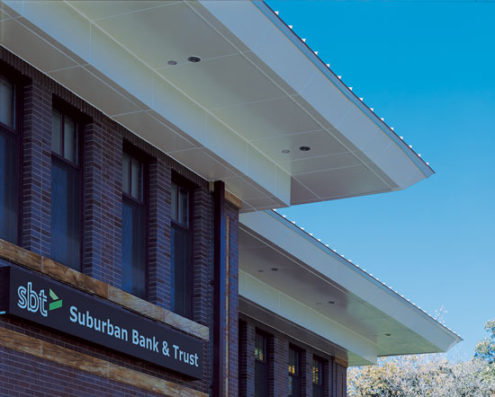 Retrofit metal soffits and fascia using flush composite panels give an existing bank building a fresh new look and improve the weather-ability of the structure.