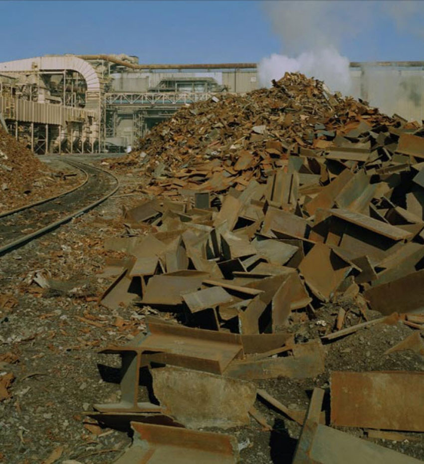 Shown is segregated scrap grades in a scrap storage yard await recycling into structural steel.