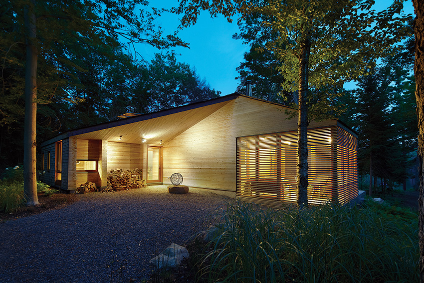 Photo of Pattern siding of red cedar on the outside of a building in the woods.