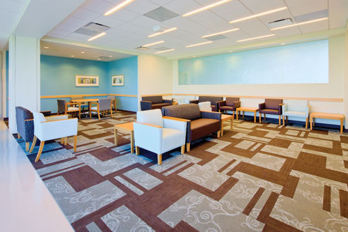 The waiting area at Banner Ironwood Medical Center, designed in hues of a serene winter palette, includes adjacent ambient light, views and decorative glazing to the patient and staff corridor.