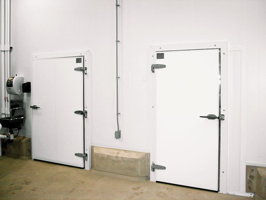 Swinging cold storage doors can be sized and located for people to access readily on foot or with handheld carts.