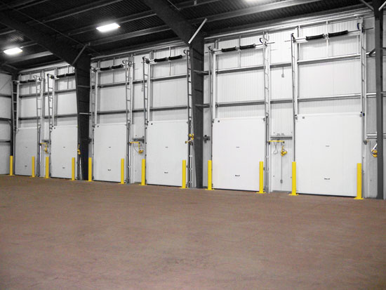 Vertical track cold storage doors, shown here from the outside and inside of the building, are best suited for loading dock applications or where horizontal clearance is not otherwise available.