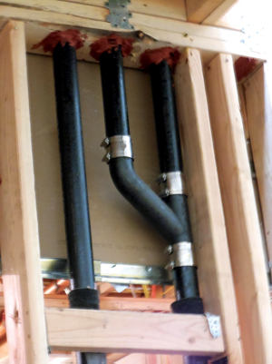 Plumbing joints with pipes nested in joint to allow for vertical movement of structure. 