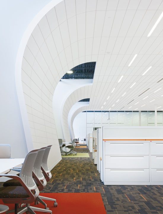 Extending the ceiling to become part of a wall system creates a visual and acoustical enclosure.