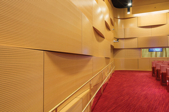 Undulating acoustically treated wood panels and strips of acoustical material can be arranged to create random sound diffusion and add to the visual experience of rooms as well.