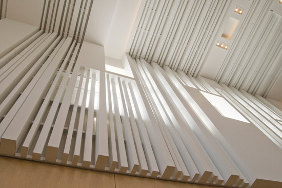 Undulating acoustically treated wood panels and strips of acoustical material can be arranged to create random sound diffusion and add to the visual experience of rooms as well.