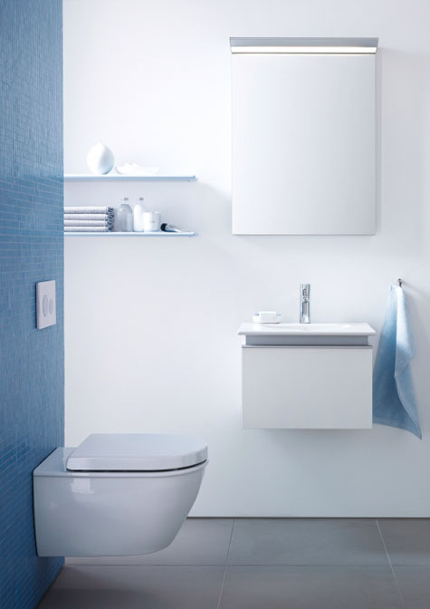 Azure blue introduces a colorful accent to a small bathroom that appears larger through the use of light colors, large-format tiles, LED lighting and abundant open space.