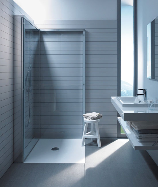 This innovative shower enclosure opens  visual and usable space by folding away between uses.