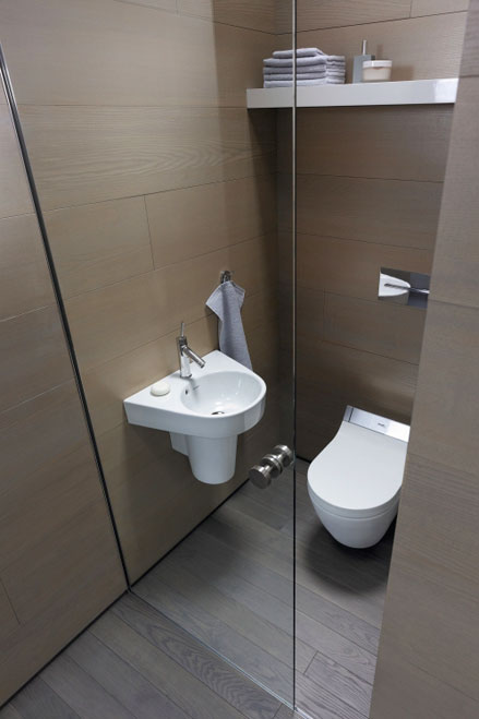 Wallboards with wide shelves make use of space above toilets.