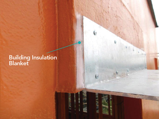 Installing a building insulation blanket behind the sunshades at the Kiln Apartments helped the architects meet Oregon building codes and Passive House standards.