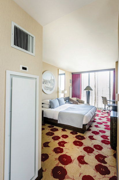 Designed by GREC Architects, Hotel Palomar in Chicago, Illinois, provides an elevated level of guest comfort and achieves energy efficiency goals with a highly efficient water-source heat pump system integrated into the hotel room interior as a wall panel.