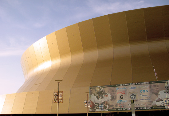 To restore and resurface the Mercedes-Benz Superdome after Hurricane Katrina, the architect Brad McWhirter, AIA, of Trahan Architects, specified 365,000 square feet of anodized aluminum panels colored to match the 1975 original façade.