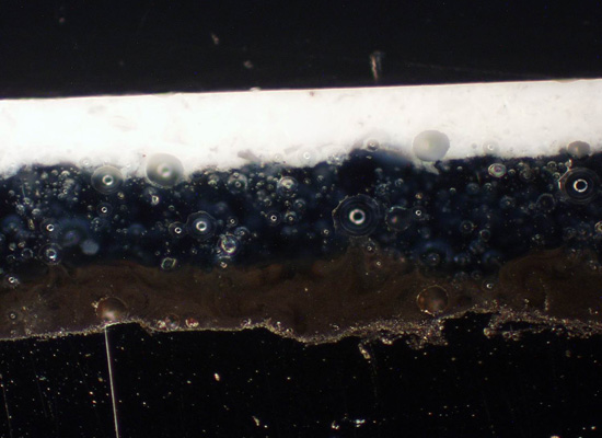 100x magnification showing the three-coat-one-fire (3c1f) coating with titanium dioxide white interior; bubbles are finer which allows flexibility plus a hard impermeable coating.