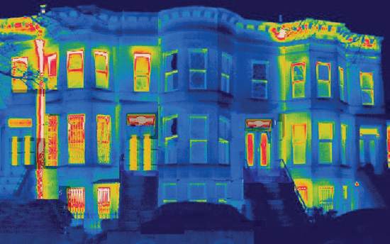 Thermal imaging shows areas of heat loss in an older townhouse building. High levels are seen at the windows, doors, and window-wall interface, as well as the roof-wall interface behind the cornice. The house in the middle was retrofitted with high-performance European windows, and this thermal image shows significant reductions in energy loss.