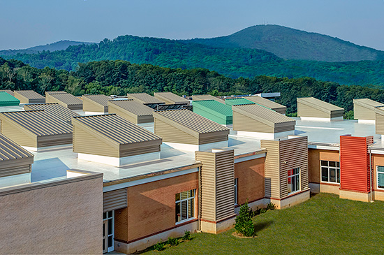 Sustainability was a driving directive for the design of the Eblen Intermediate School provided by Architectural Design Studio, Asheville, N.C. This LEED Silver-certified project uses 14,000 square feet of Petersen Aluminum metal roof and wall panels in Bone White, Champagne, Colonial Red and Arcadia Green. Large vertical skylights are roofed in Tite-Loc Plus panels.