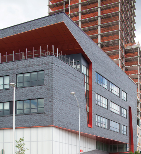 The striking color of the brick on the Community School at Hunter’s Point Campus in New York also serves as a durable and efficient cladding. 