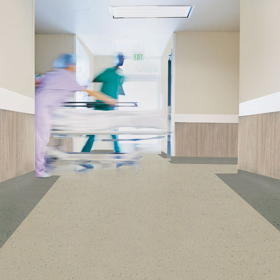 Resilient flooring can provide the design benefits of non-directional color and enhanced surface finish treatments even in high-demand environments such as healthcare settings and schools.
