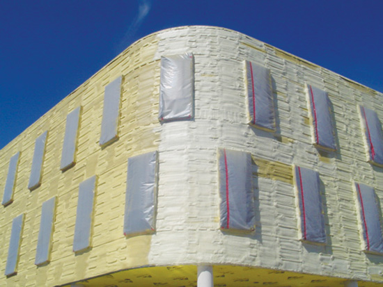 Spray foam insulation can be applied to curved and irregular surfaces while also readily sealing around other wall features such as windows.