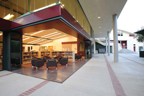 Folding glass doors connect interior spaces with the outdoors. At the Viewpoint School in Calabasas, California, Kalban Architects used a zero post corner system to completely open up the Fletcher Family Library to the courtyard when desired.