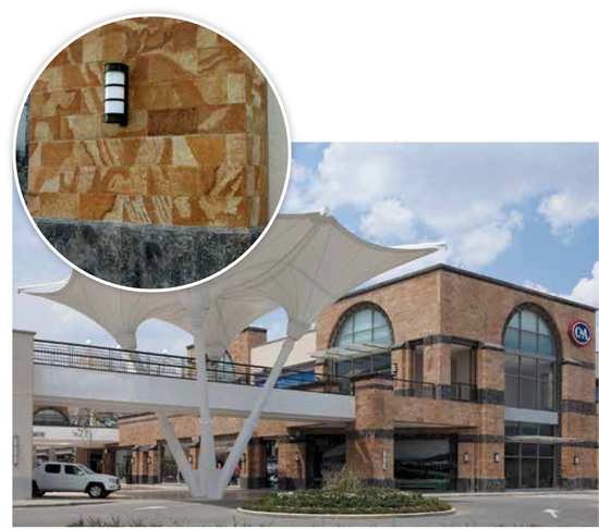 This large outdoor mall in Mexico used a precast concrete enclosure system that combined pigments, formliners, acid etching, and chiseling techniques to emulate the black and orange natural stone. Precast concrete reduced the overall time and cost of the project relative to using the natural stone. 