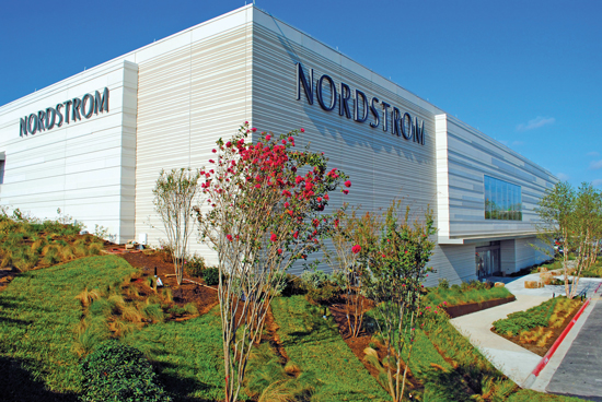 Nordstrom is using precast concrete to create its new high-performance enclosure system that is being used in all of the stores around the country. The precast panels provide edge-to-edge, continuous insulation and serve as the air and vapor barrier, providing a very efficient enclosure system. Aesthetically, four different finishes are combined on one panel: sandblast, acid etch, polished, burnished, and the use of formliners to create horizontal bands at different widths and depths. 