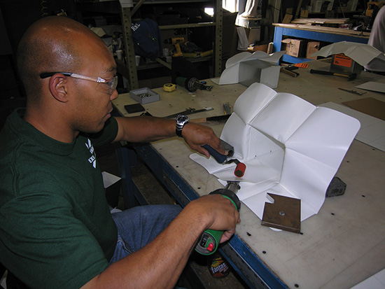 A custom prefabricated flashing is made inside a factory-controlled setting.