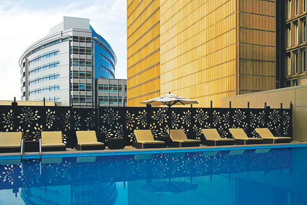 Architectural panels with patterned openings were used to provide a pool security screen and to hide rooftop air condensers for the Denver Downtown Sheraton Hotel.