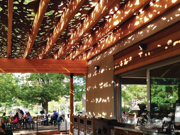 Architectural panels with patterned openings create a shaded and comfortable outdoor space in the Hive Garden Bistro at the Denver Botanic Gardens.