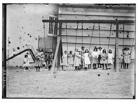  An early North American playground with swings and a slide.