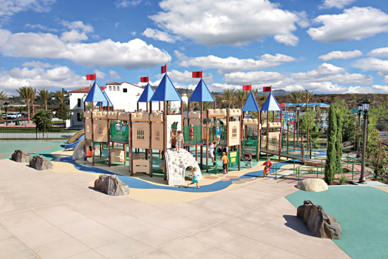  A modern playground in San Clemente, California, has a castle theme and provides places for play on upper and ground levels.