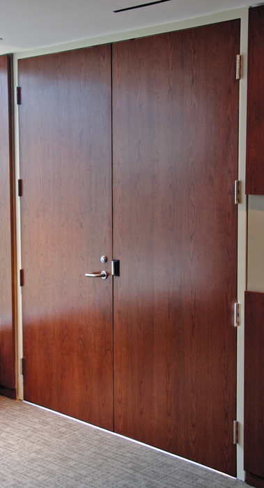 Specialized door, frame, and window systems can be specified to meet performance standards and still feature aesthetic qualities, such as this acoustic wood door and steel frame system achieving an STC rating of 51.