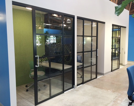 Workspace nook with ADA-compliant extended handle, these sliding glass doors are ideal for workers requiring a quiet, heads-down space or a private zone for small meetings.