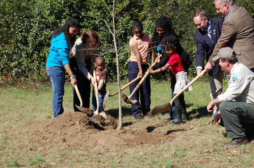Photo of Jones family planting a tree.