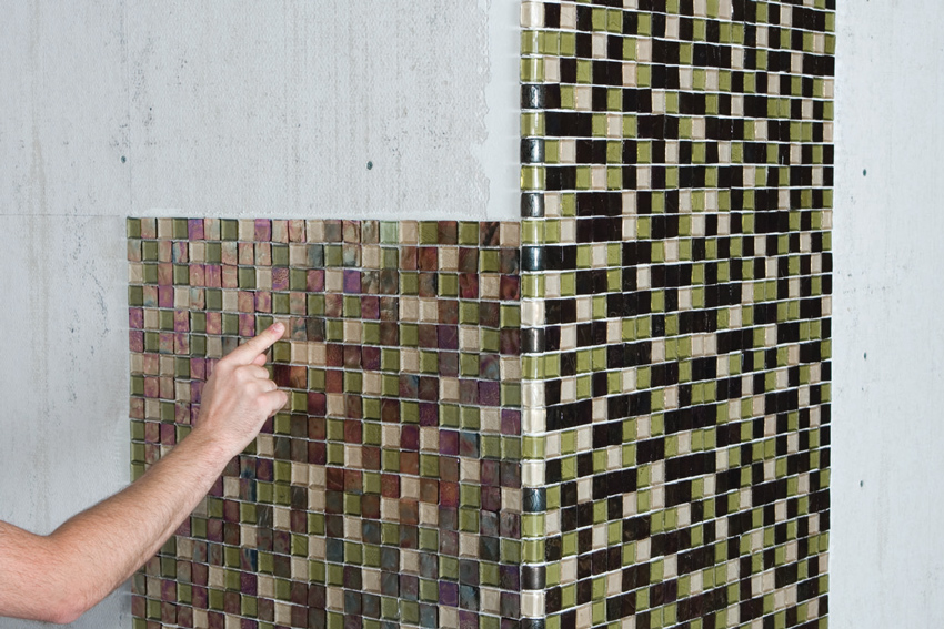 For mosaic installation with paper facing, installers lightly tap with a wooden beating block and finish hammer and later lightly wet the face papers to release the glue. Then the paper is peeled while the setting material is fresh to allow for adjustments.