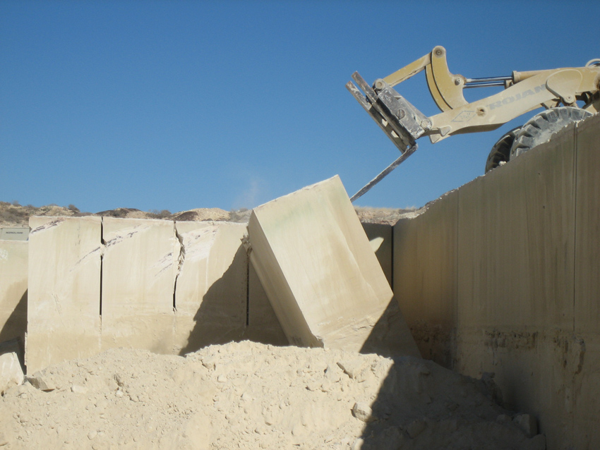 Quarry operations of limestone involve cutting large blocks and then tipping or leaning them onto their side to be carried to the mill. 