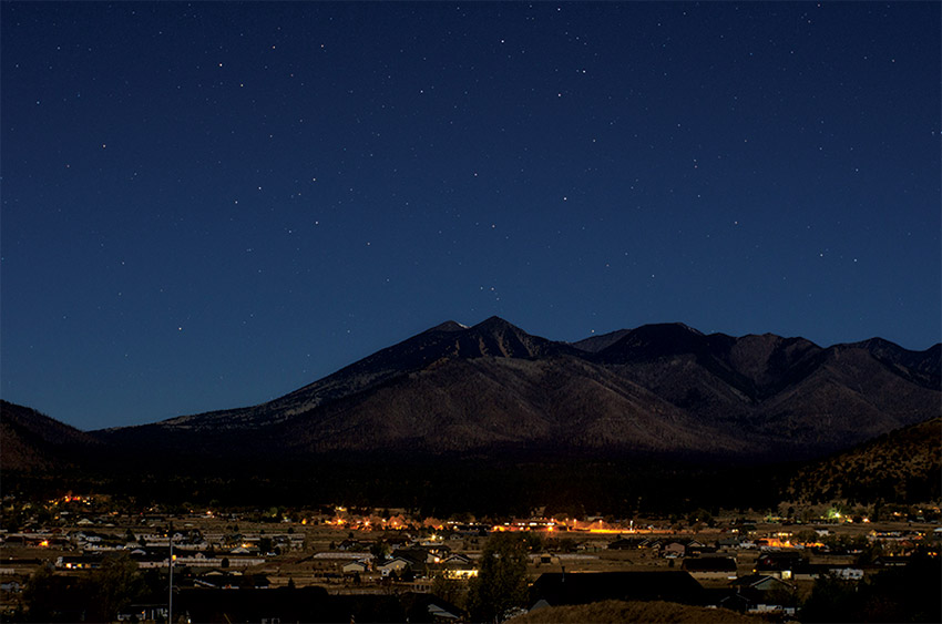 Photo of a town under a night sky.