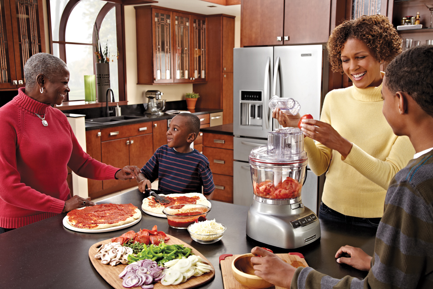 Photo of a family around a kitchen counter.