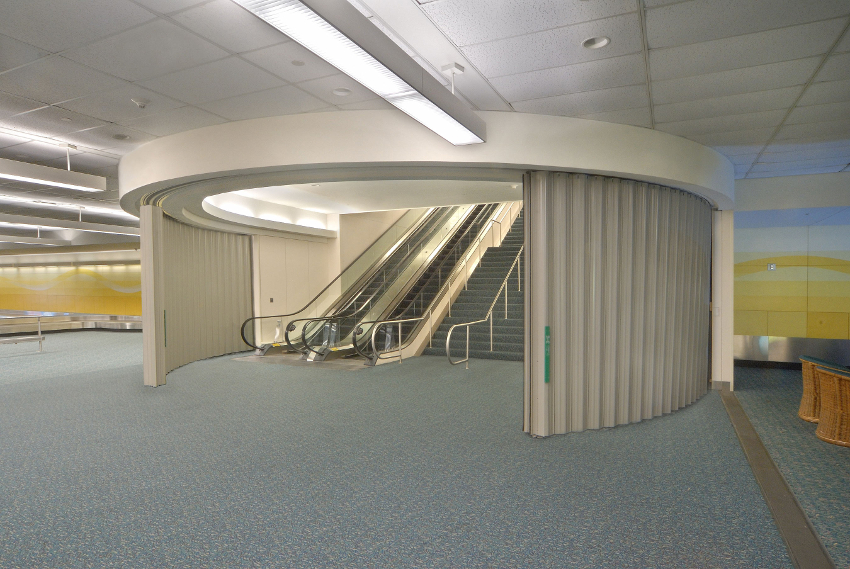 Photo of curved sliding fire doors around multistory stairways.