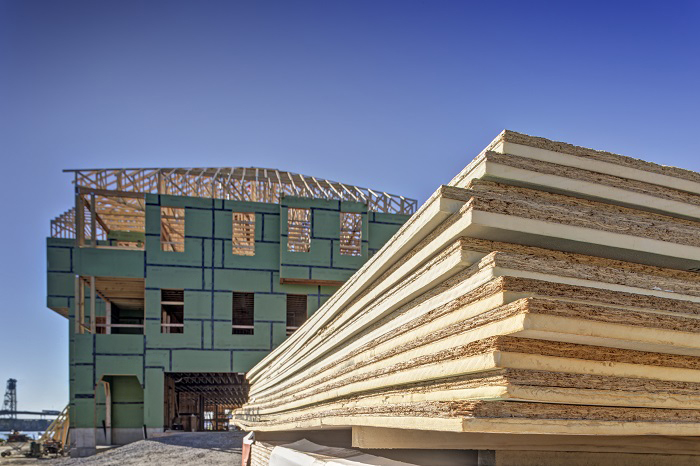 Photo of a house under construction with insulation visible.