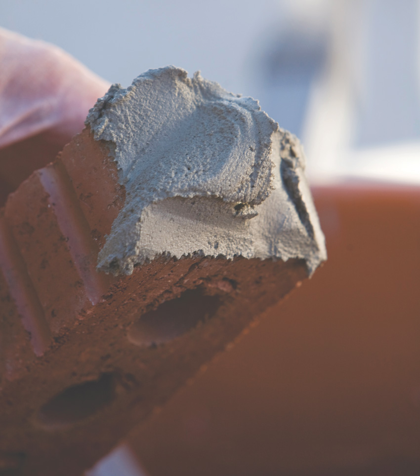 Photo of a brick with mortar.