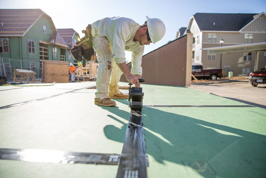 construction worker using a roll tape system