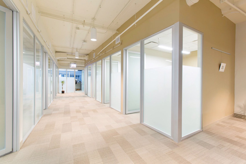 Photo of clinic's hallway with glass partitions.