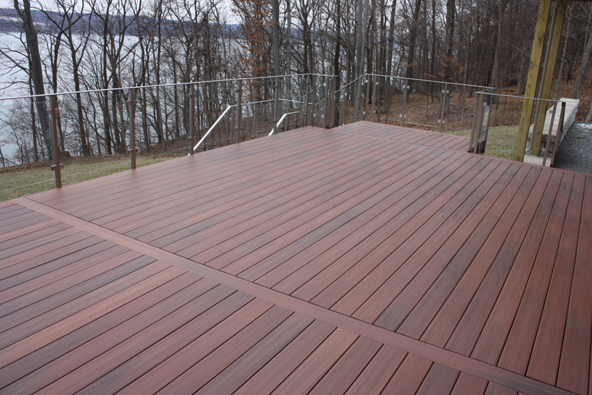 A side-mounted glass railing system extends the views from this deck in Lansing, New York.