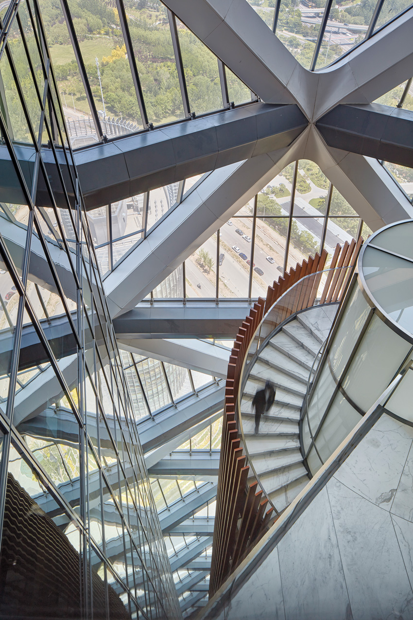 Photo of steel structures inside a building with marble floors.