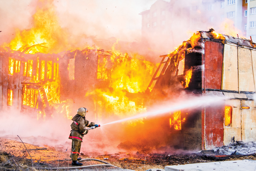 Photo of firefighter putting out a fire