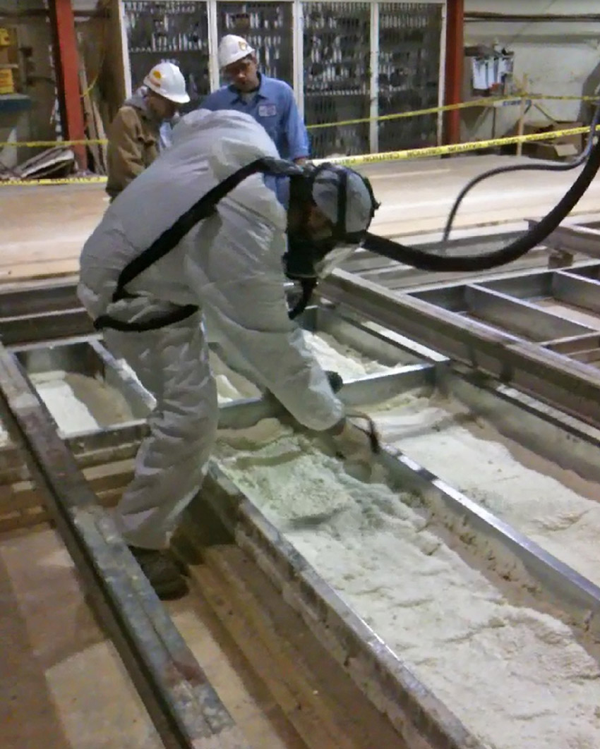 Image of workers sealing factory-applied foam insulation seals any air gaps of a thermal wall system